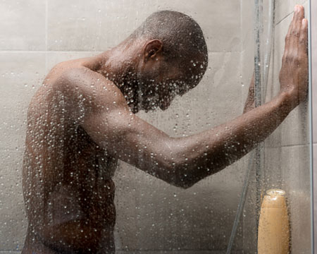 man taking shower - when did indoor plumbing start