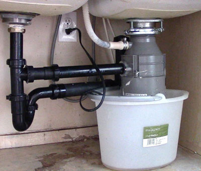 Garbage disposal problems - bucket placed under food waste disposer to begin work on poor draining issue