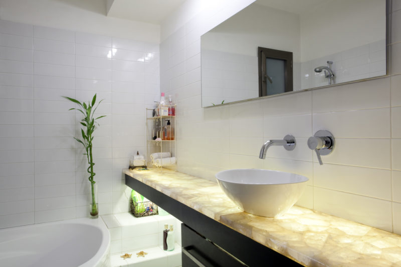 2021 bathroom trends - minimalist lighting and large tiles and freestanding vanity