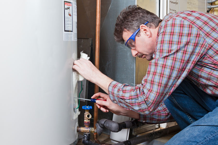 water heater maintenance - homeowner checking instructions on water heater