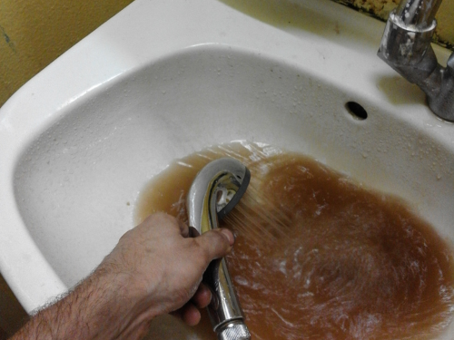 Brown water coming out of a sink. 